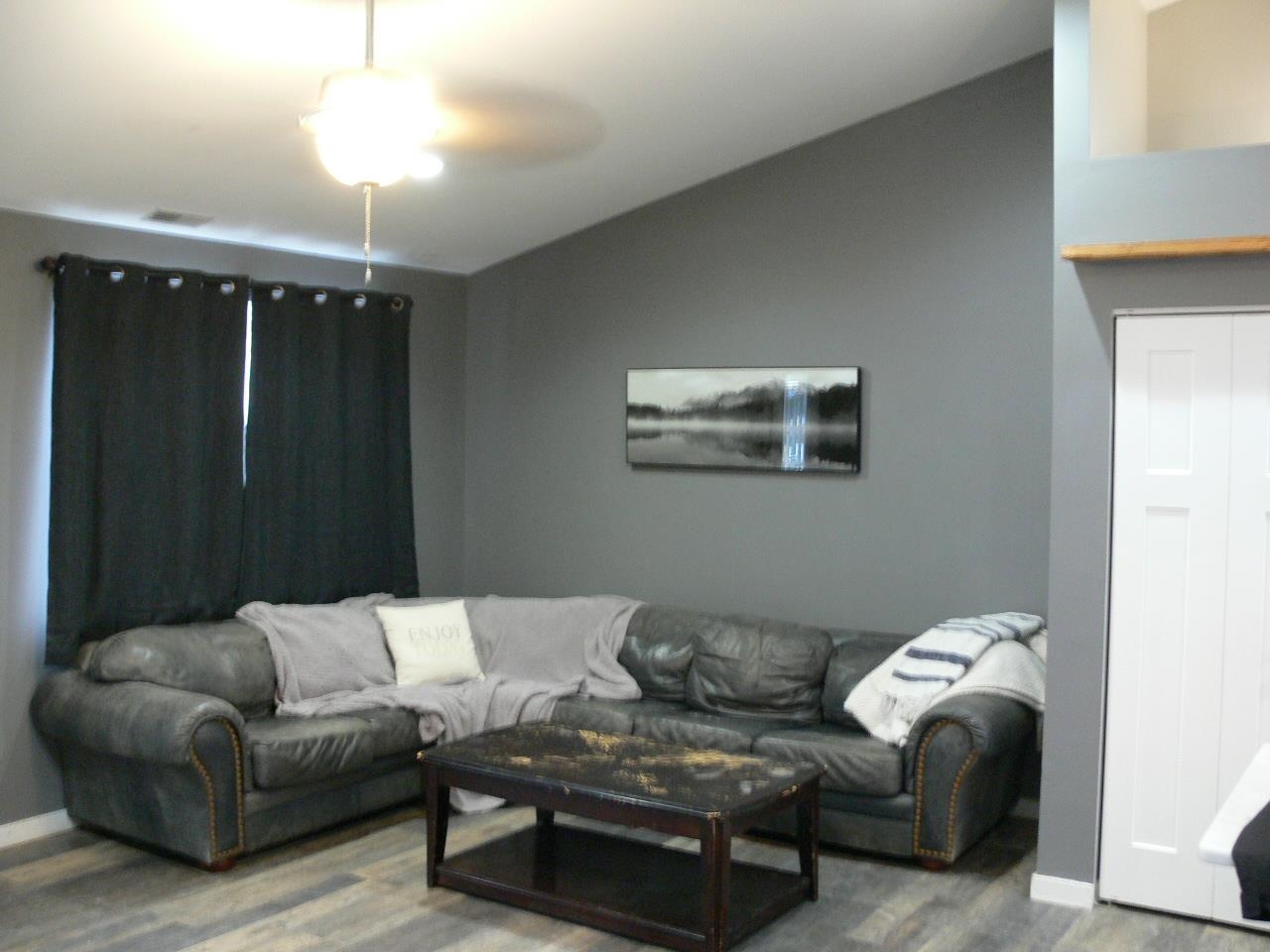 4223 Ostrander Road Rockford, IL 61107 - Photo 18 of 20 a living room with furniture and a chandelier