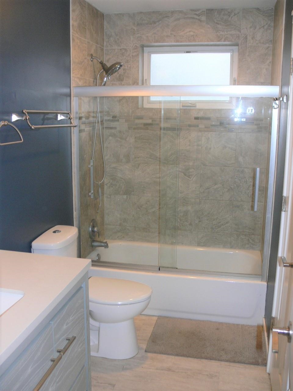 4223 Ostrander Road Rockford, IL 61107 - Photo 8 of 20 a bathroom with a shower a toilet and a sink