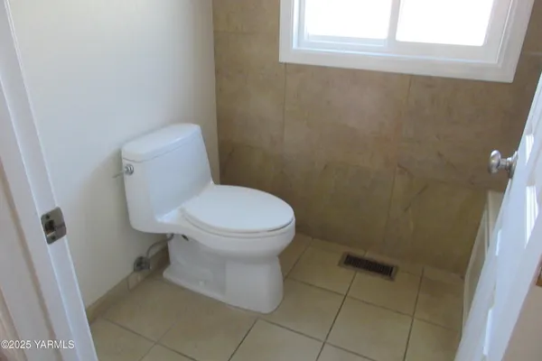 a white toilet sitting next to a window