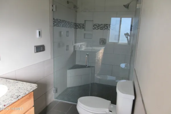 a white toilet sitting next to a bathroom sink and vanity