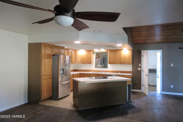 a kitchen with stainless steel appliances granite countertop a stove and a refrigerator