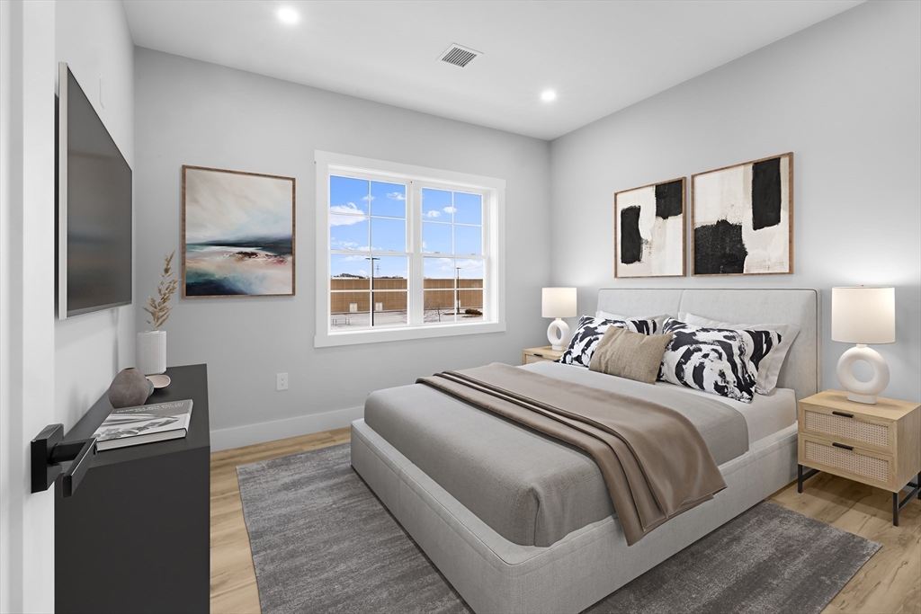 889-895 Grinnell Street, Unit 7 Fall River, MA 02721 - Photo 21 of 37 a bedroom with a large bed and a flat tv screen
