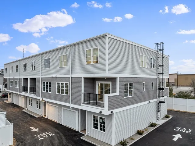 a large white building with a view of a house