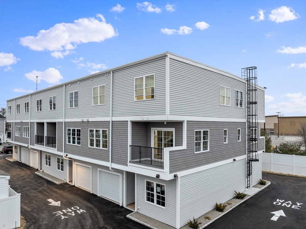 889-895 Grinnell Street, Unit 7 Fall River, MA 02721 - Photo 3 of 37 a large white building with a view of a house