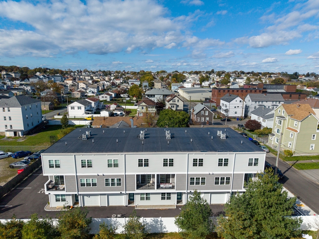 889-895 Grinnell Street, Unit 7 Fall River, MA 02721 - Photo 37 of 37 an aerial view of residential building with streets and trees