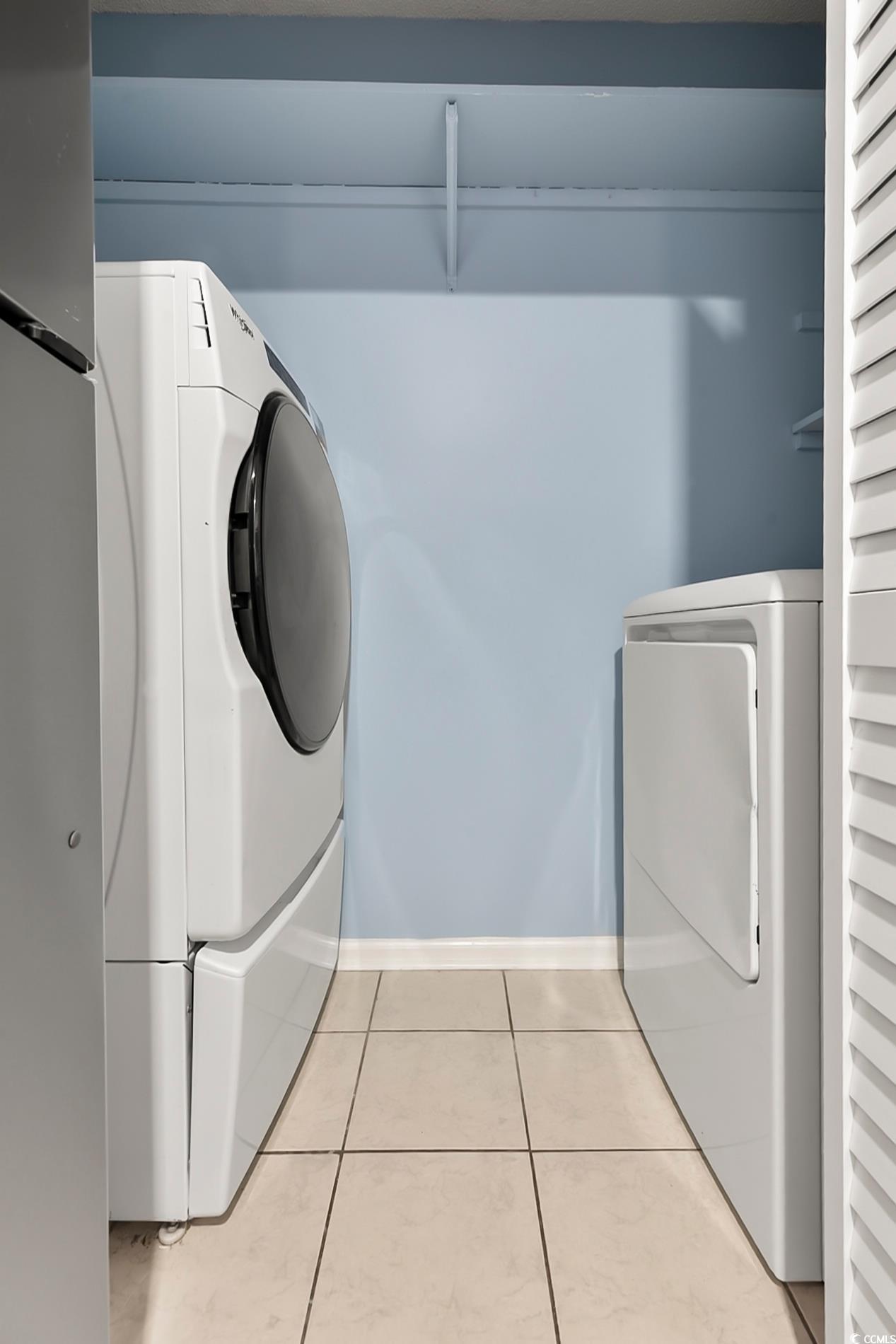4150 Horseshoe Road North, Unit 38 Little River, SC 29566 - Photo 13 of 29 Laundry room with tile patterned floors and washing machine and clothes dryer