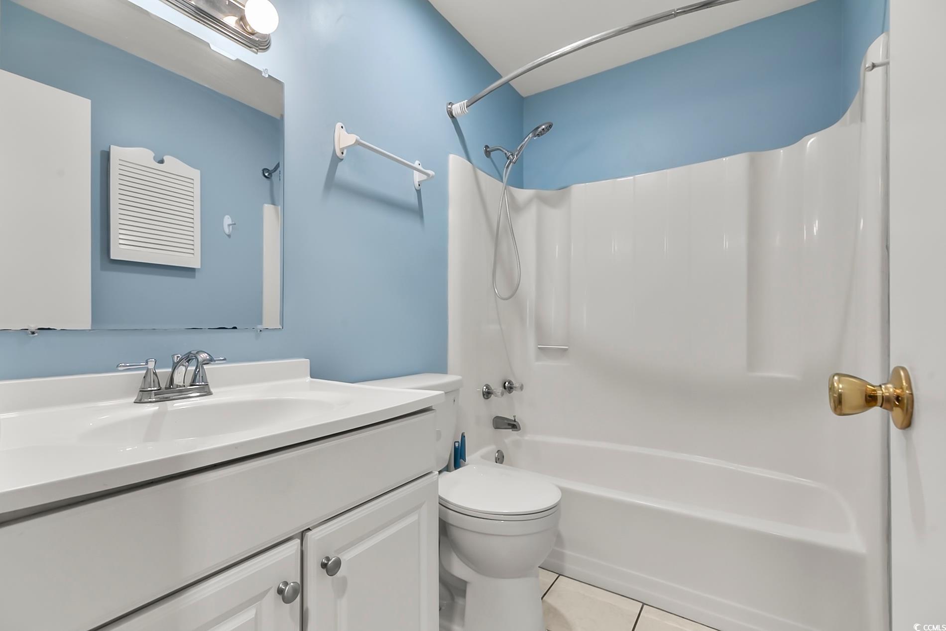 4150 Horseshoe Road North, Unit 38 Little River, SC 29566 - Photo 14 of 29 Bathroom with vanity, shower combination, and light tile patterned flooring