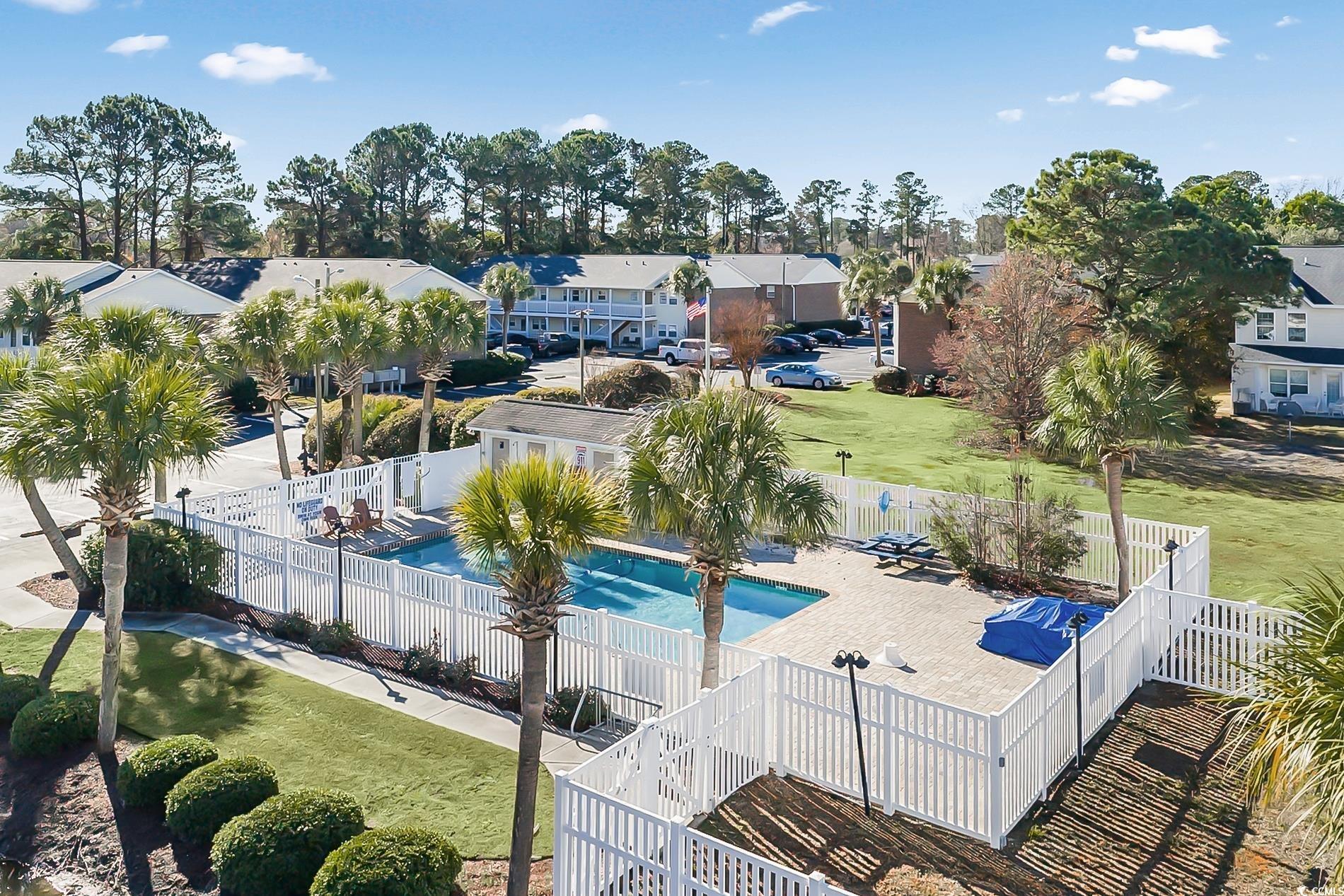 4150 Horseshoe Road North, Unit 38 Little River, SC 29566 - Photo 25 of 29 Community pool featuring a residential view and a fenced backyard