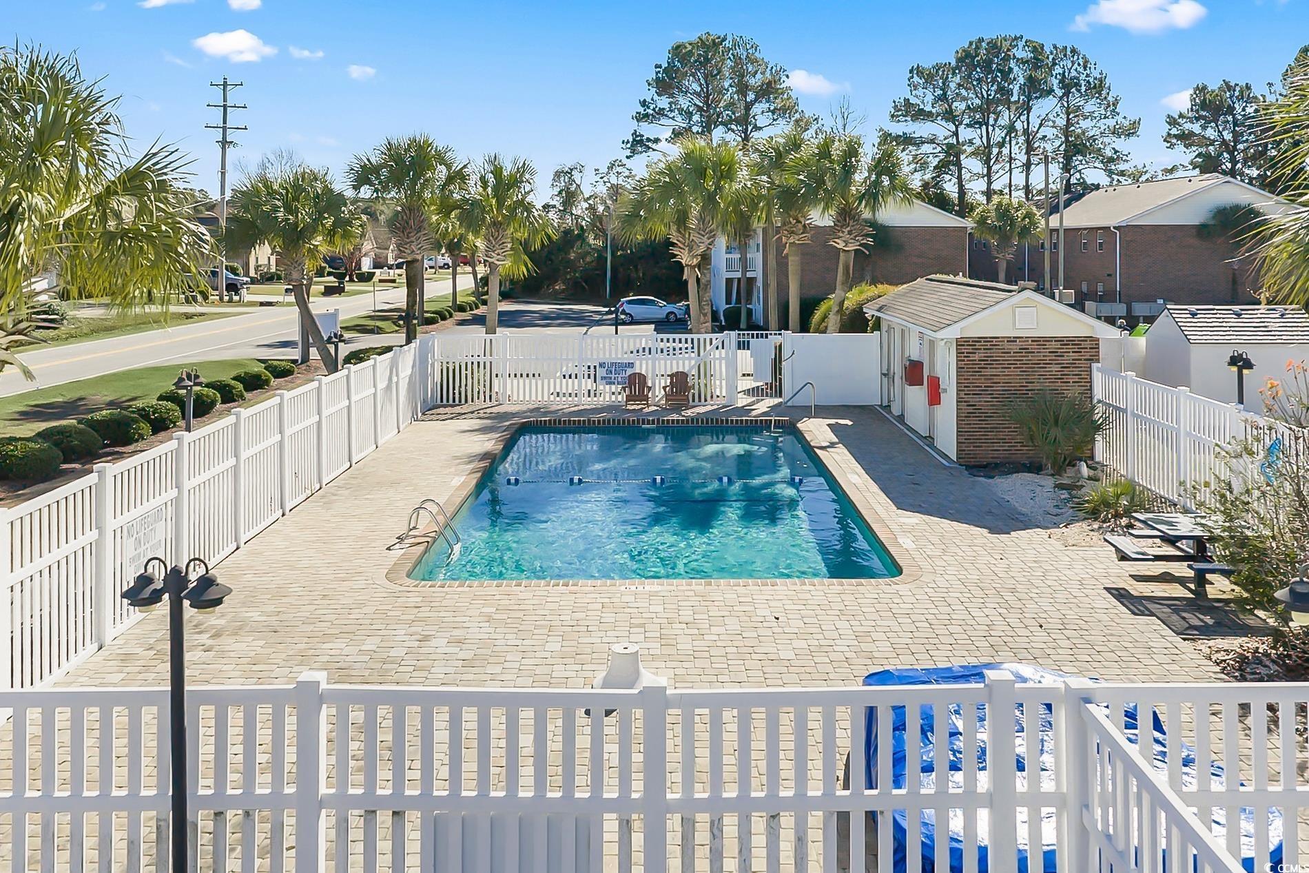 4150 Horseshoe Road North, Unit 38 Little River, SC 29566 - Photo 27 of 29 Community pool with a fenced backyard, a patio area, and an outdoor structure
