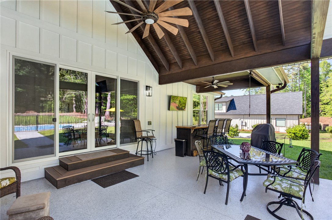 921 Falling Waters Lane Seneca, SC 29672 - Photo 34 of 46 A spacious covered patio provides an inviting outdoor entertainment area, complete with ceiling fans and ample seating.