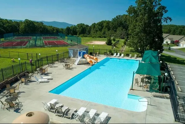 a view of a swimming pool and lounge chairs