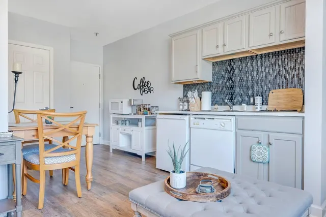 a kitchen with stainless steel appliances kitchen island granite countertop a table and chairs