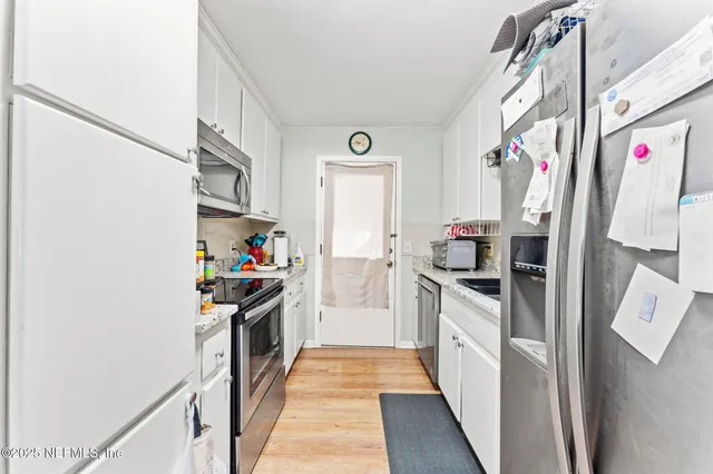 a kitchen with a refrigerator and a stove