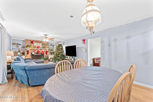a living room with furniture a flat screen tv and a large window