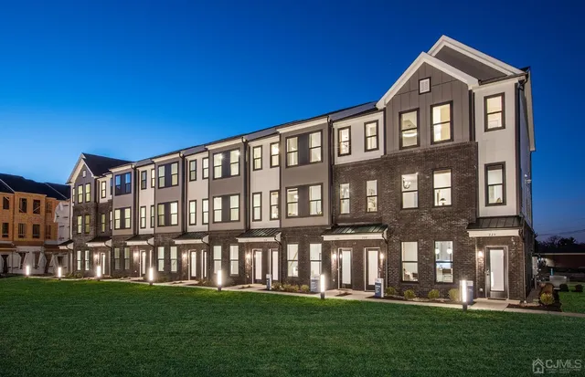 a front view of building with yard and green space