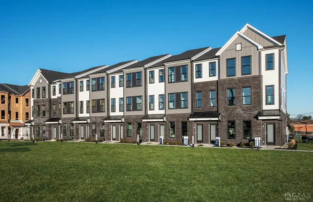 a front view of building with yard and green space