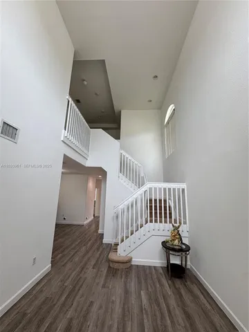 a bathroom with a sink vanity and shower