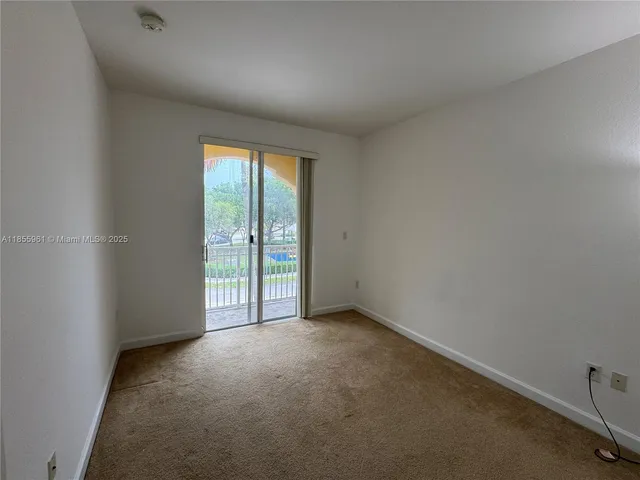 a living room with a bed furniture and a window