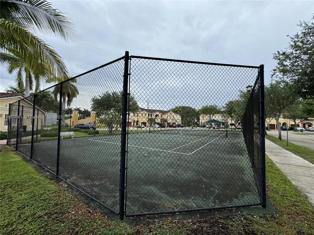 a living room with furniture pool table and a flat screen tv