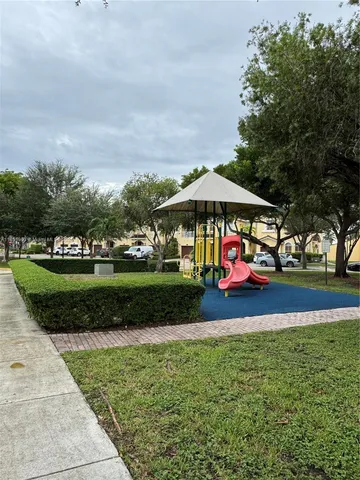 a view of a backyard with wooden fence