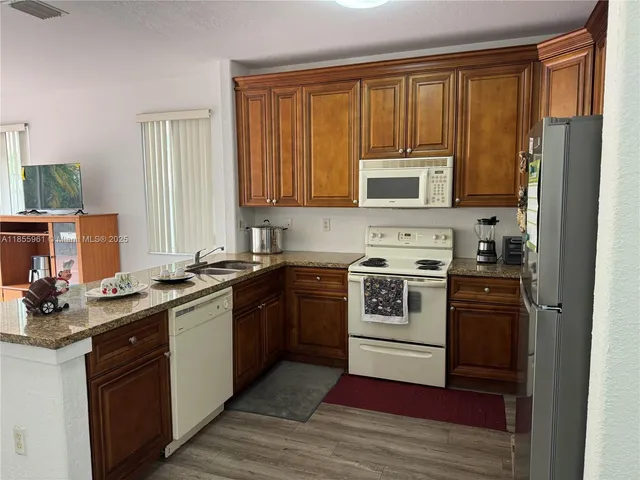 a kitchen with a stove a sink and a microwave