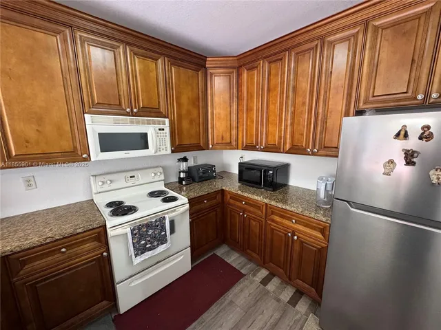 a kitchen with a refrigerator stove and sink