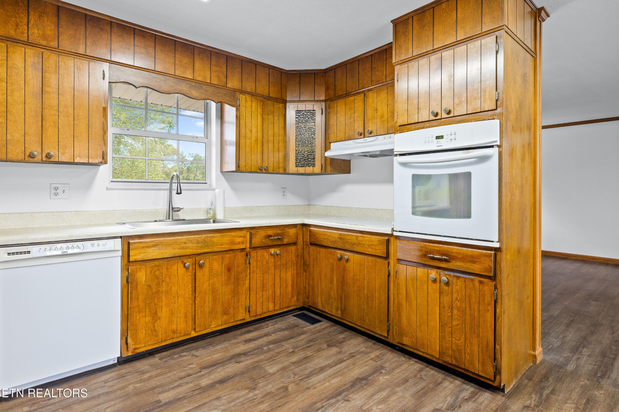 804 Chilhowee View Road Maryville, TN 37803 - Photo 12 of 38 a kitchen with stainless steel appliances granite countertop wooden cabinets a sink and a large window