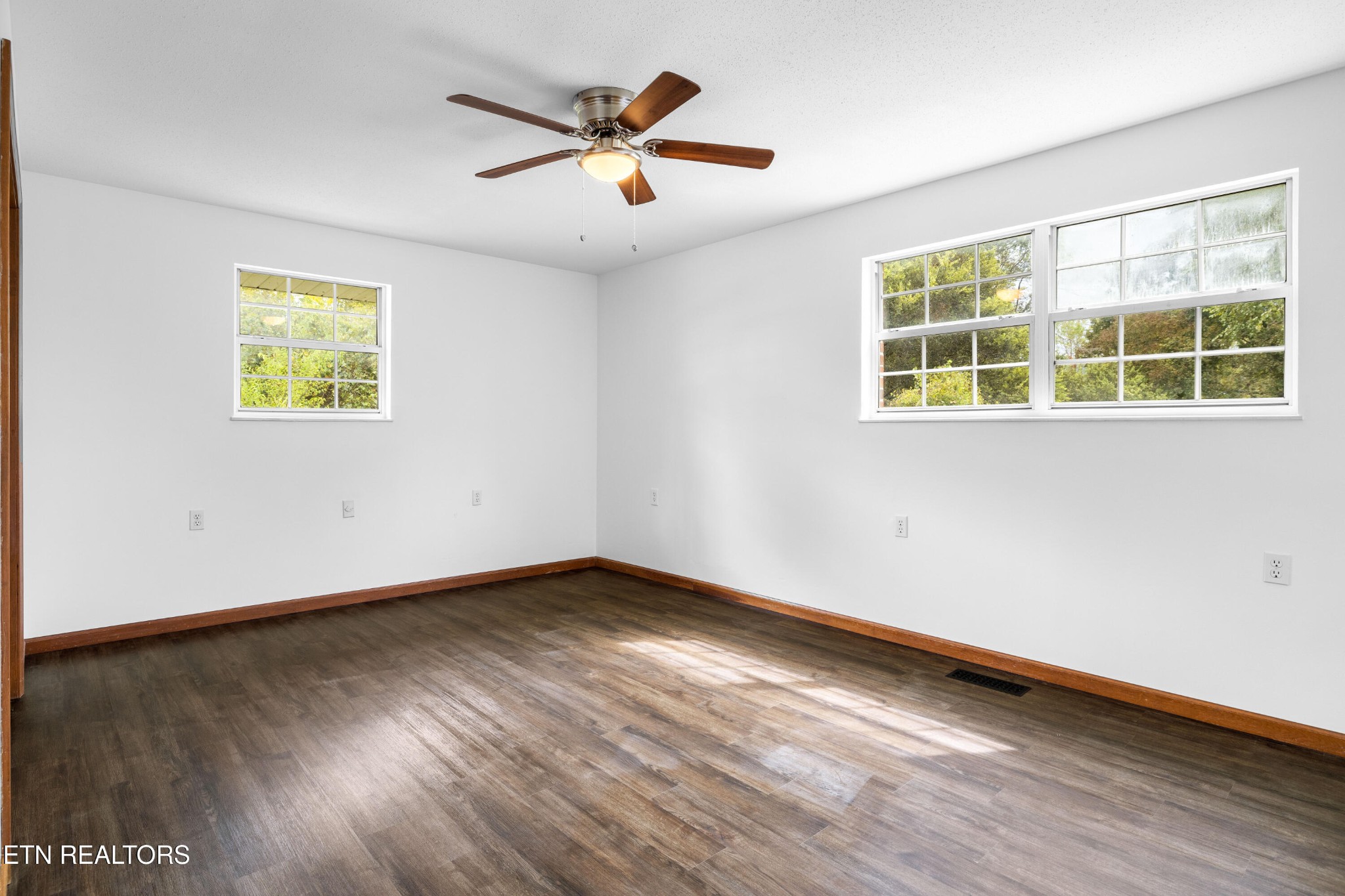 804 Chilhowee View Road Maryville, TN 37803 - Photo 17 of 38 a view of an empty room with wooden floor and a window