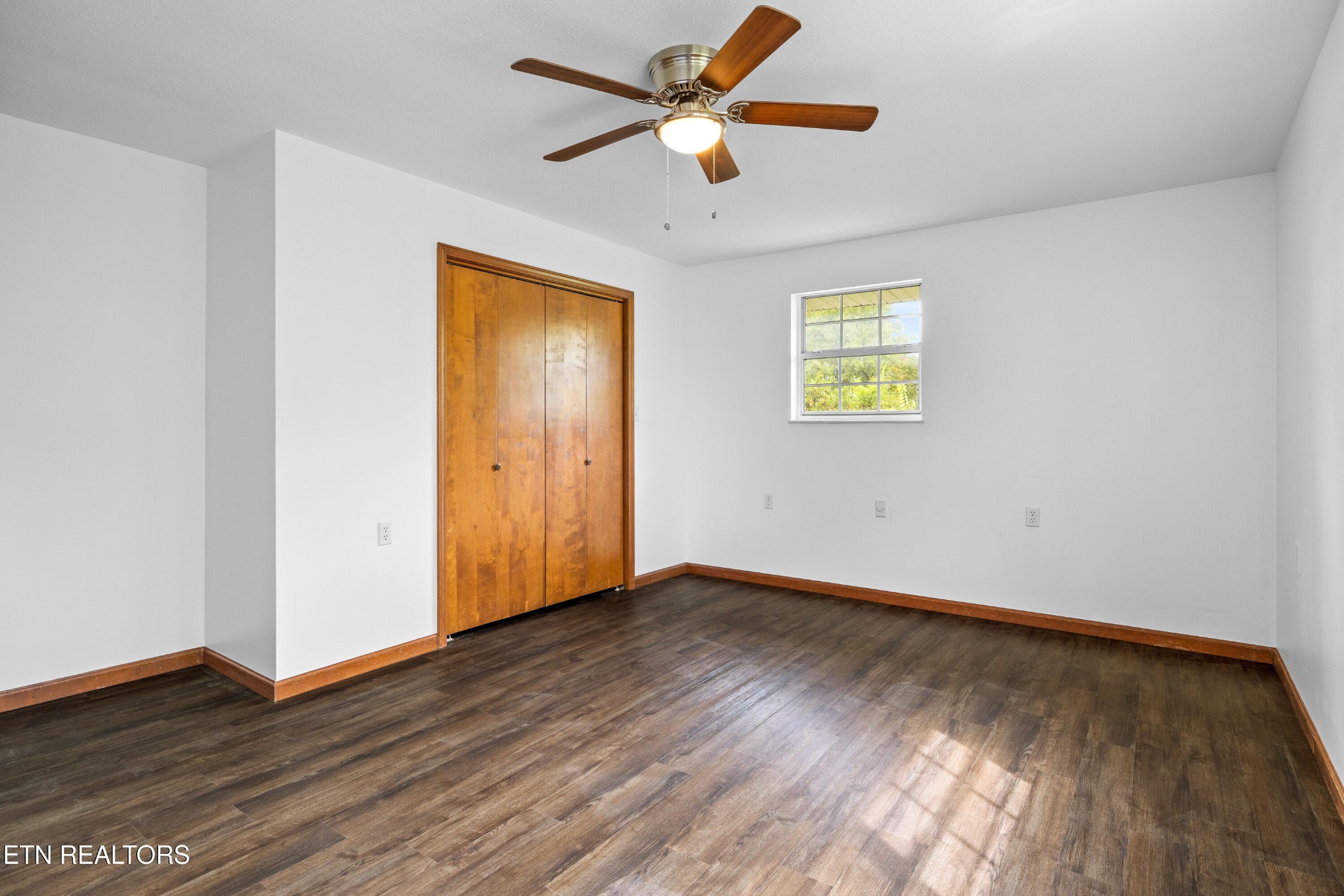 804 Chilhowee View Road Maryville, TN 37803 - Photo 18 of 38 an empty room with wooden floor chandelier fan and windows