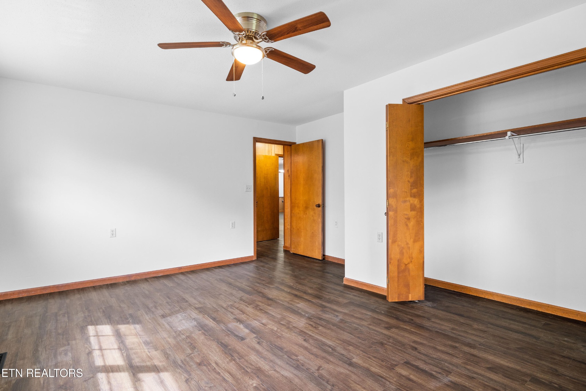 804 Chilhowee View Road Maryville, TN 37803 - Photo 19 of 38 an empty room with wooden floor closet and windows