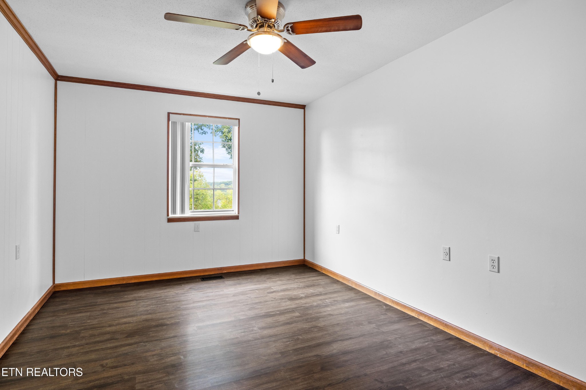 804 Chilhowee View Road Maryville, TN 37803 - Photo 21 of 38 an empty room with wooden floor ceiling fan and windows