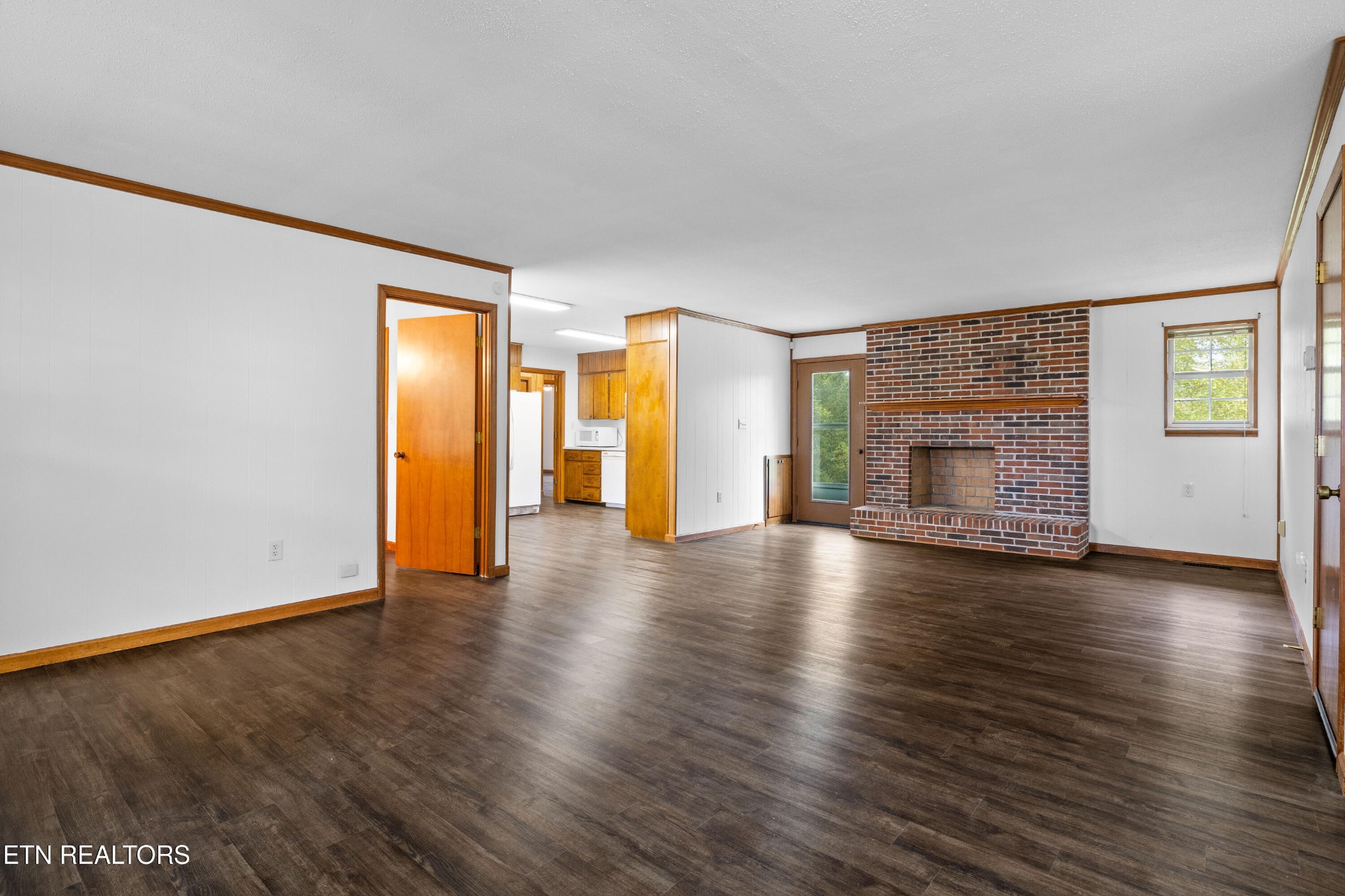 804 Chilhowee View Road Maryville, TN 37803 - Photo 4 of 38 a view of empty room with a fireplace and wooden floor
