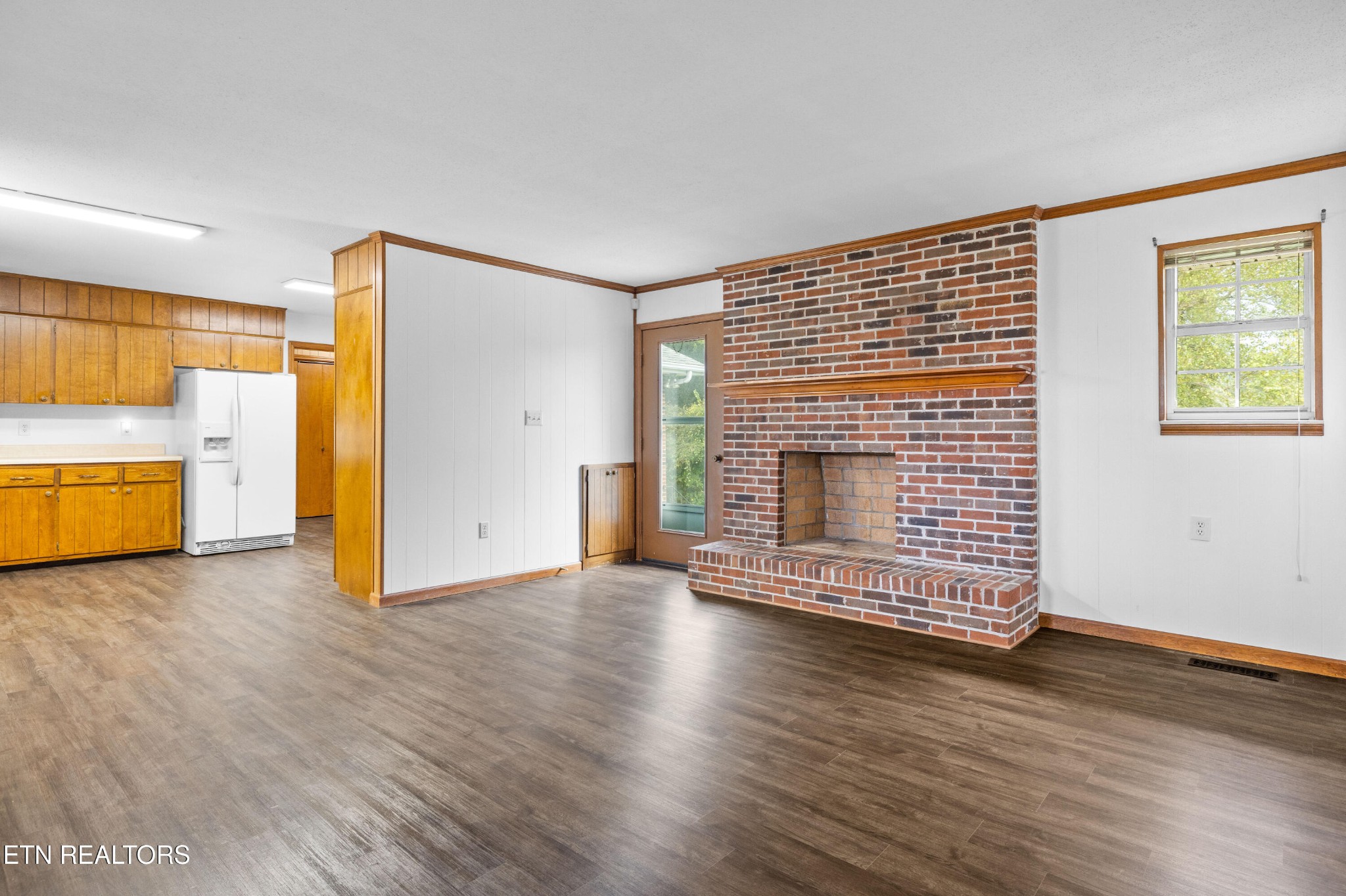 804 Chilhowee View Road Maryville, TN 37803 - Photo 5 of 38 a view of a livingroom with wooden floor and a fireplace