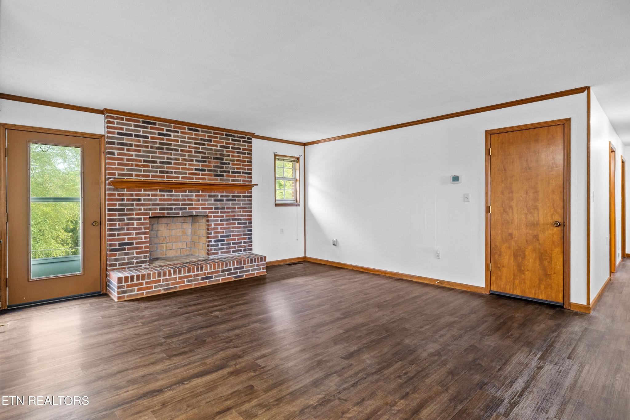 804 Chilhowee View Road Maryville, TN 37803 - Photo 7 of 38 an empty room with wooden floor and windows