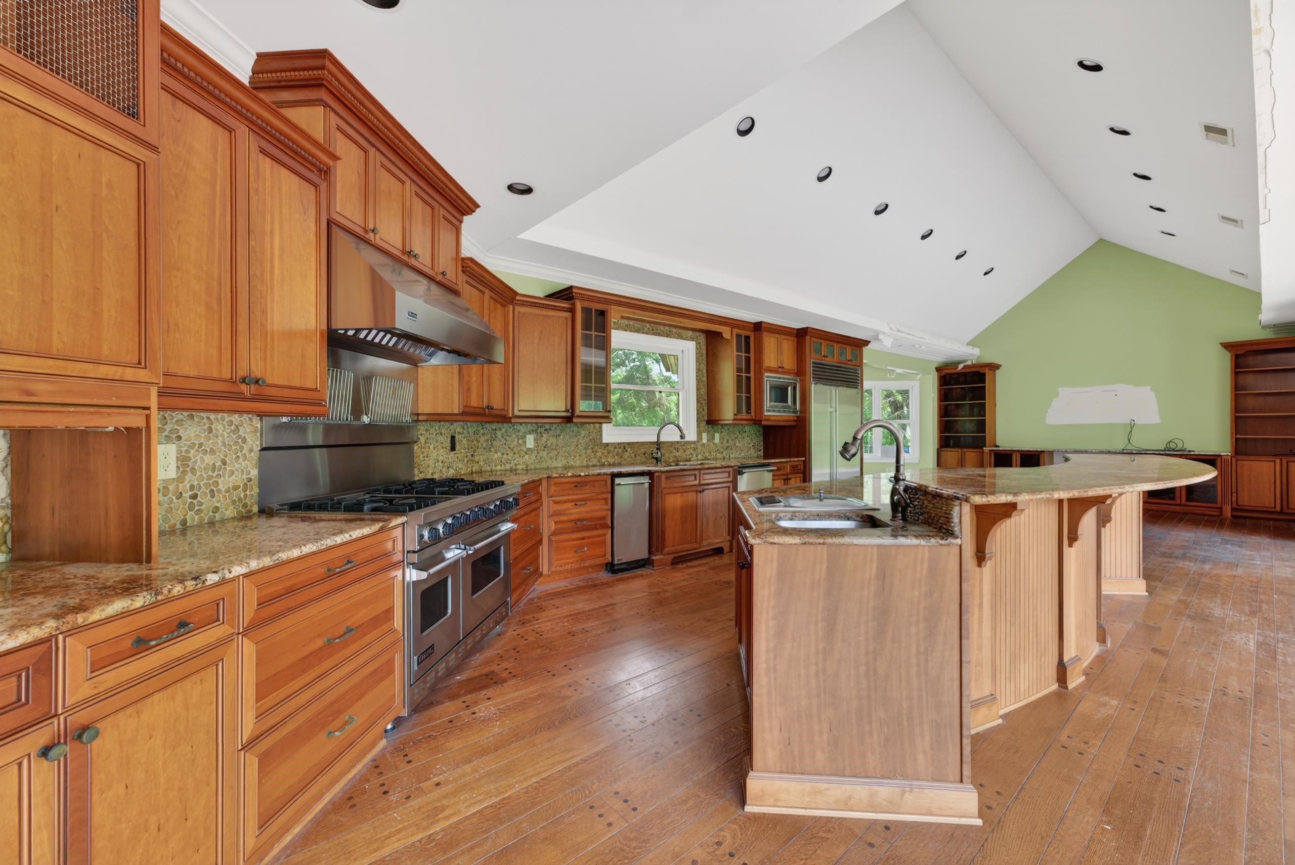 530 West Raines Road Memphis, TN 38109 - Photo 11 of 38 Spacious kitchen featuring warm wood cabinetry, granite countertops, and a stone tile backsplash