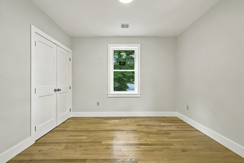 4 Mayhew Street Framingham, MA 01702 - Photo 26 of 42 a view of an empty room with wooden floor and a window