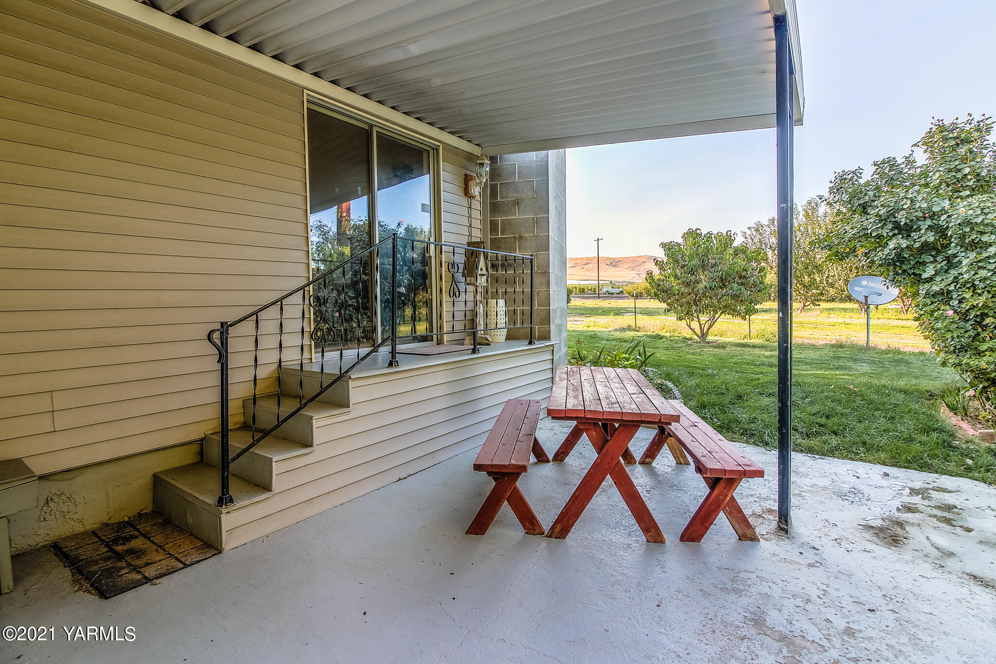 681 Lateral A Road Wapato, WA 98951 - Photo 16 of 19 a view of a patio with table and chairs potted plants with wooden fence
