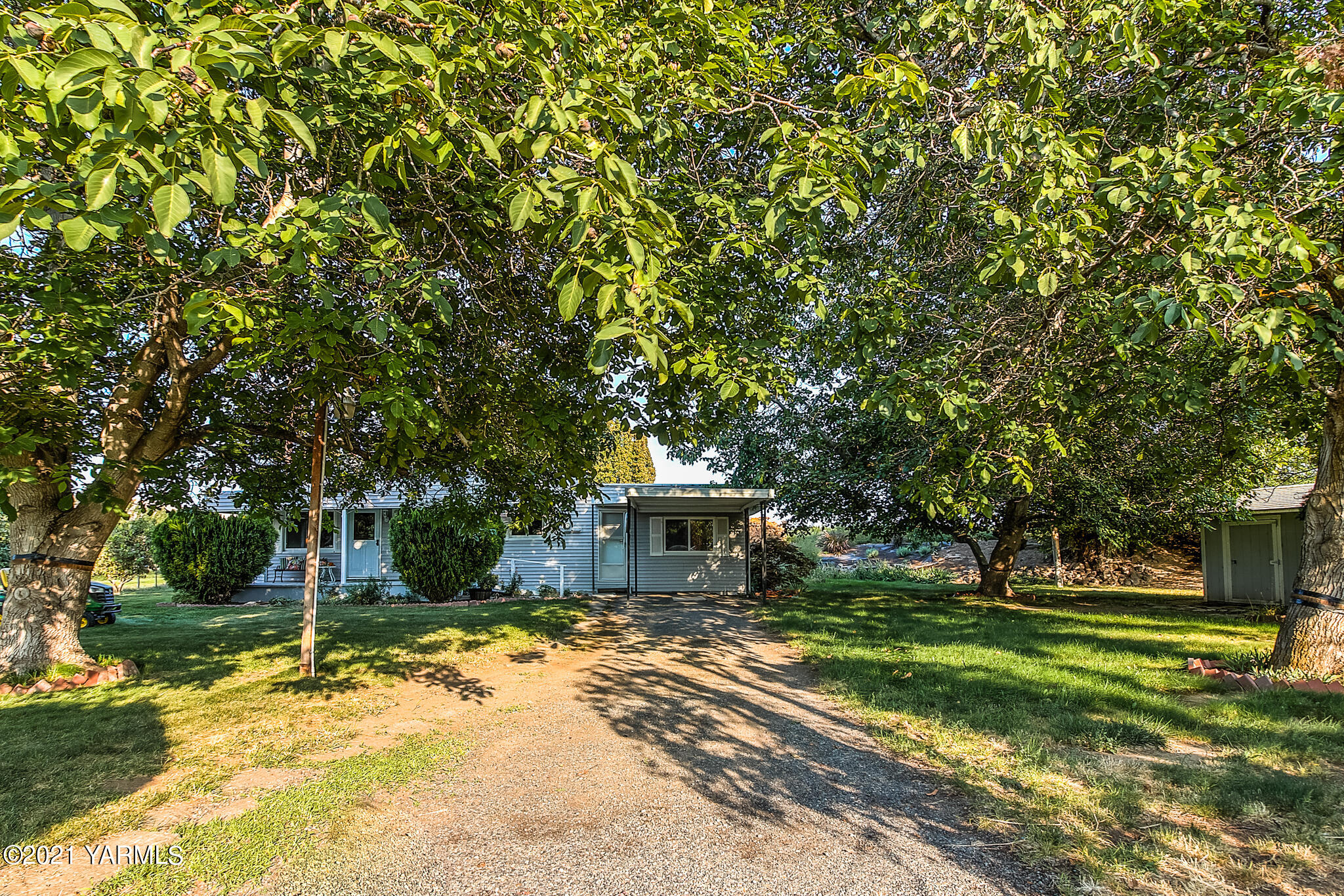 681 Lateral A Road Wapato, WA 98951 - Photo 4 of 19 a front view of a house with a yard and trees