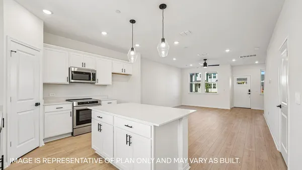 a view of a kitchen with electric appliances