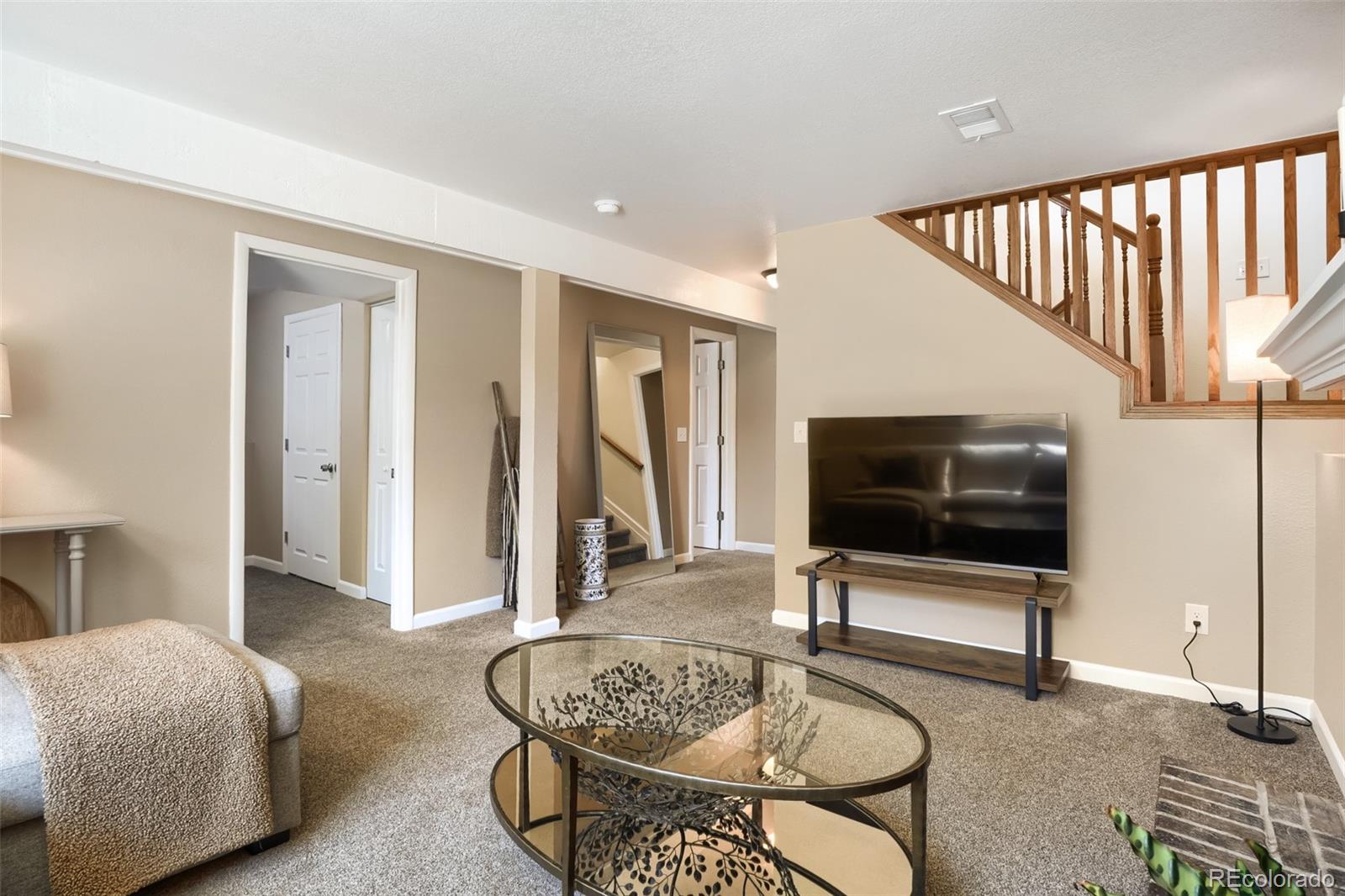 6551 South Albion Way Littleton, CO 80121 - Photo 18 of 37 a living room with furniture and a flat screen tv