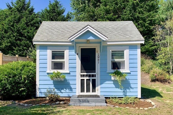 a view of a house with entrance door and garden