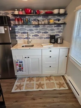 a bedroom with a bed and a flat tv screen on the dresser