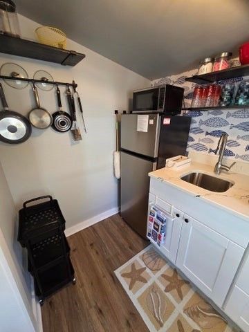 1061 State Highway, Unit 4 Eastham, MA 02642 - Photo 14 of 27 a bedroom with a bed and a flat tv screen on the dresser