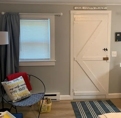 a bedroom with a bed and painting on the wall