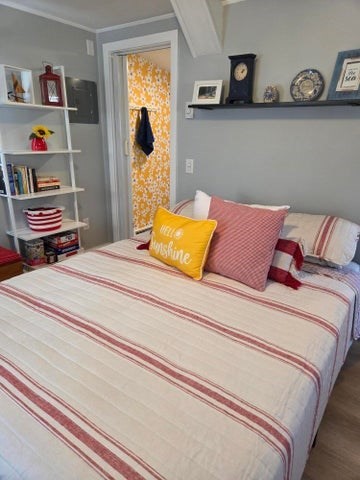 1061 State Highway, Unit 4 Eastham, MA 02642 - Photo 7 of 27 a bedroom with a bed and dresser