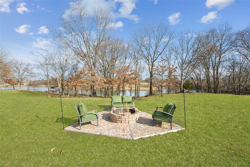 370 Private Road 5291 Yantis, TX 75497 - Photo 31 of 40 a view of a white house with a yard table and chairs