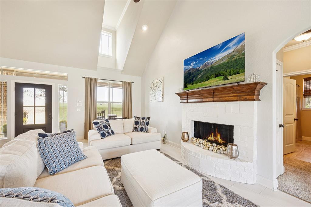 370 Private Road 5291 Yantis, TX 75497 - Photo 4 of 40 a living room with furniture a flat screen tv and a fireplace