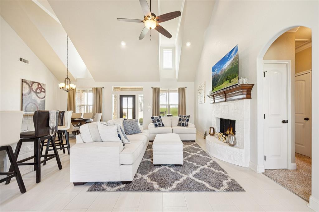 370 Private Road 5291 Yantis, TX 75497 - Photo 8 of 40 a living room with furniture a fireplace and a flat screen tv