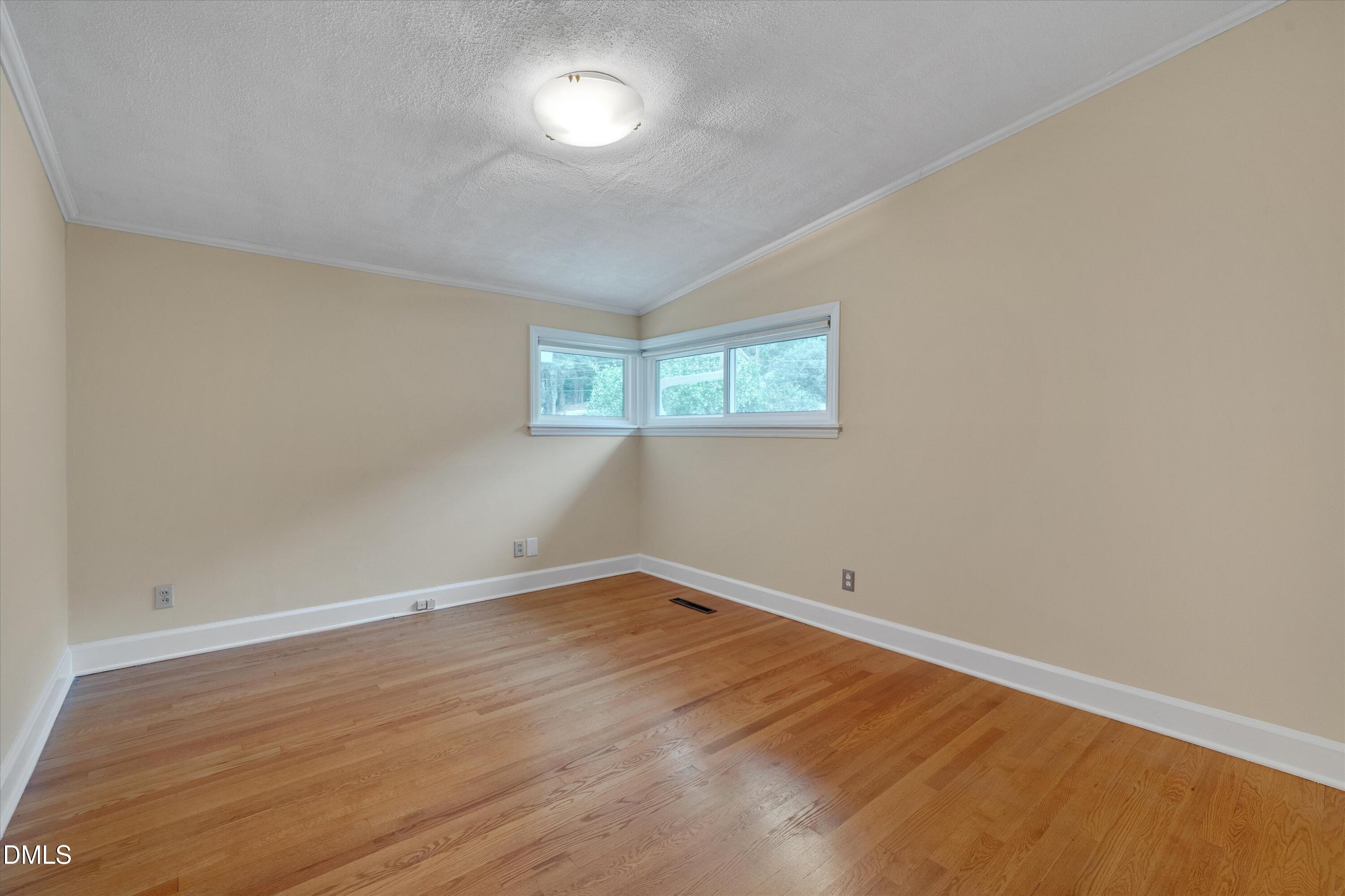 1617 Shawnee Street Durham, NC 27701 - Photo 8 of 56 an empty room with wooden floor and windows