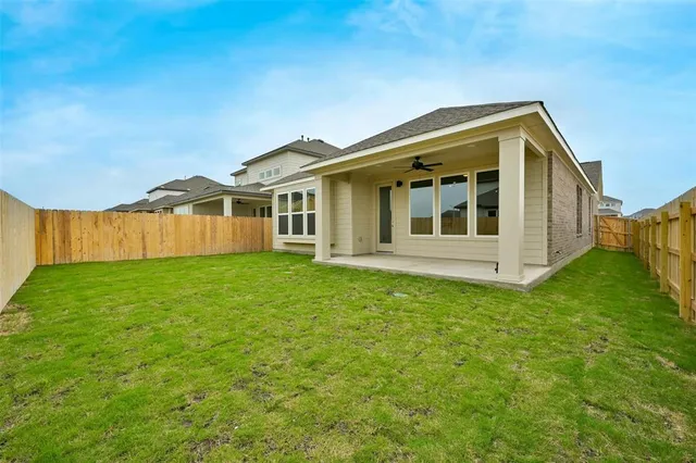 a view of a house with a backyard